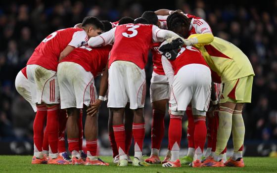 Arsenal team huddle at start of the second half during the English Premier League match between Chelsea and Arsenal in London, Britain, 30 November 2025.
